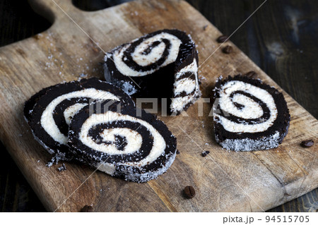 chocolate roll with a creamy curd layer in coconut chips 94515705