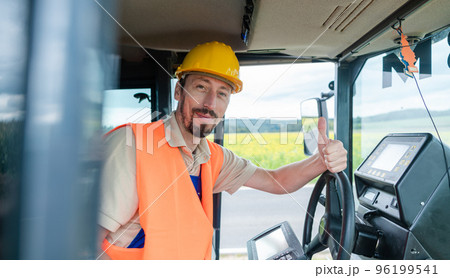 Construction worker on excavator planning the work to be done 96199541