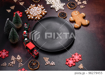 Home festive Christmas table decorated by toys and gingerbreads 96279455