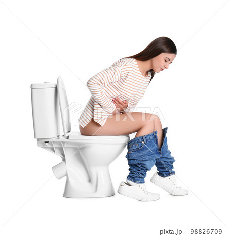 Woman with stomach ache sitting on toilet bowl, white background 98826709