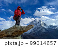 Hiker woman posing with mountains at background 99014657