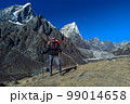 Hiker woman posing with mountains at background 99014658