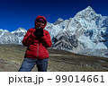 Hiker woman posing with mountains at background 99014661