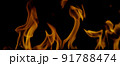 Fire Flames Igniting And Burning, Fiery orange glowing. Abstract background on the theme of fire. Real flames ignite. Royalty high-quality free stock image of overlay flames isolated on black backgrou 91788474