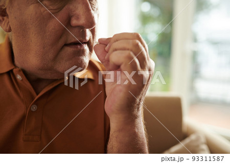 Cropped image of elderly man taking prescribed tablets to get rid of pain 93311587