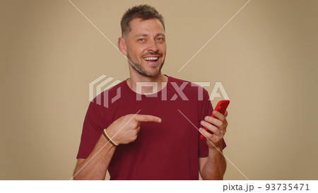 Handsome young man using smartphone show thumbs up like, positive feedback, recommends 5G connection 93735471