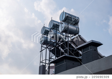 Water tanks on the roof of a residential building in Antalya, Turkey. Housing and communal services in the Turkish town. Streets and houses with water tanks on the roof to heat hot water. 105690309