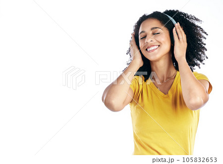 Music, happy and a woman with headphones in studio streaming audio, sound or radio. Peace, calm and african female person isolated on a white background listening to song to relax with mockup space 105832653