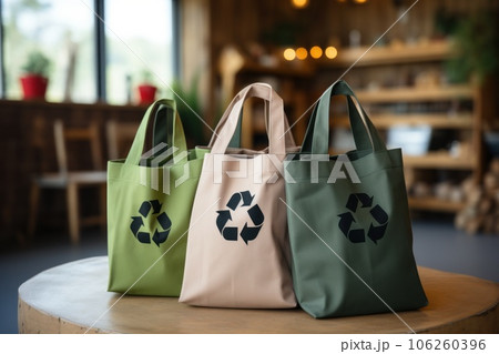 Canvas bags on a table with recycle sign and cafe background. Generative AI 106260396