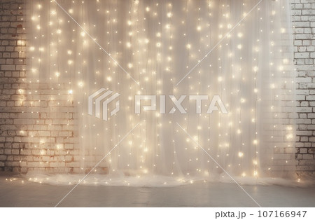 Minimalist white brick wall adorned with shimmering Christmas lights, perfect for background. 107166947