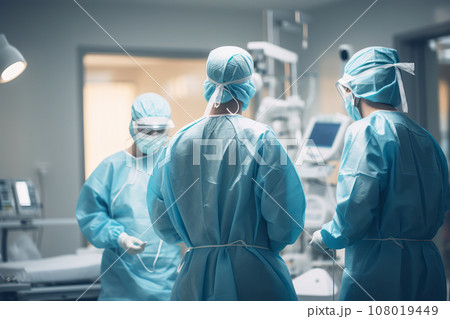 General view of a medical ward in a hospital. Doctors and healthcare workers in personal protective equipment take care of patients, fight infection during a pandemic, using modern medical equipment. 108019449