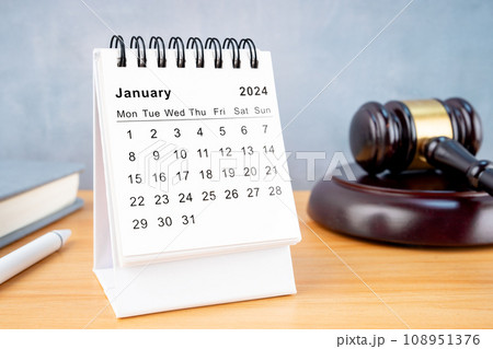 Desk calendar for January 2024 and judge's gavel. 108951376