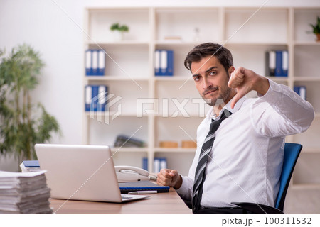 Young male employee working in the office 100311532