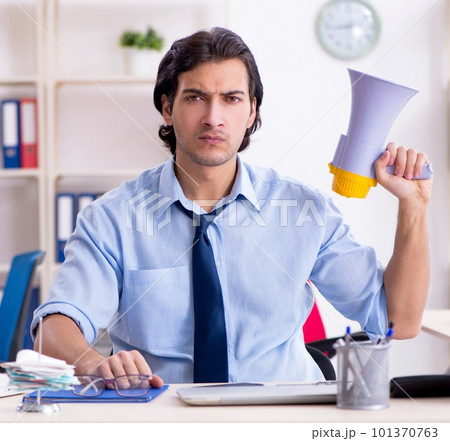 Young male businessman employee unhappy with excessive work 101370763