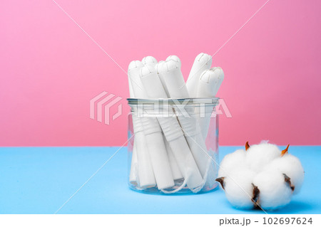 Female medical tampons on pink and blue background 102697624