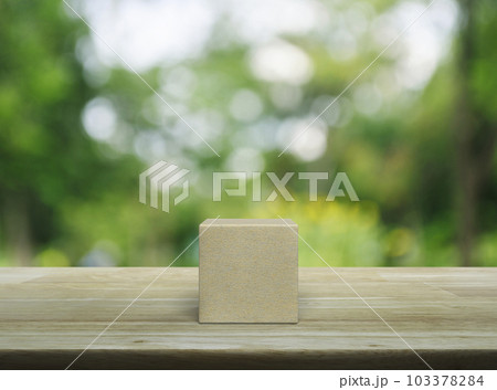 Wood block cube on wooden table 103378284