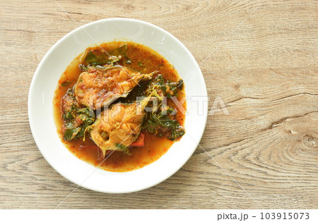 spicy fried catfish with basil and chili in curry on plate 103915073