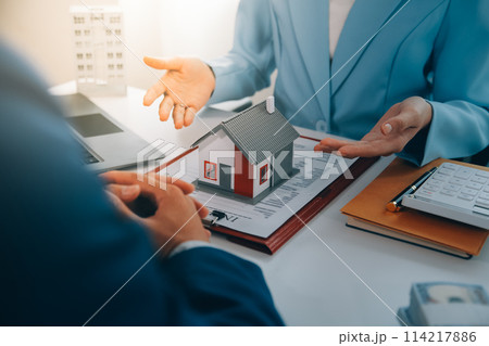 Real estate agent talked about the terms of the home purchase agreement and asked the customer to sign the documents to make the contract legally, Home sales and home insurance concept. 114217886