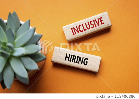 Inclusive Hiring symbol. Wooden blocks with words Inclusive Hiring. Businessman hand. Beautiful orange background with succulent plant. Business and Inclusive Hiring concept. Copy space. 115406880