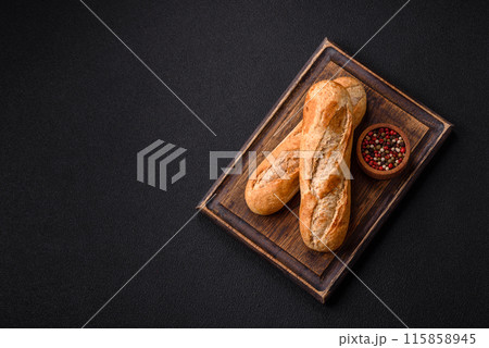 Crispy mini baguette with seeds and grains, salt and spices 115858945