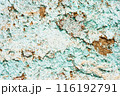 Close up of a weathered and peeling turquoise painted wall with exposed brown patches, texture, background. 116192791