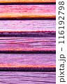 Close up of colorful wooden planks with a vibrant orange and purple hue, texture-background. 116192798