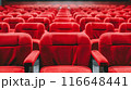 Rows of empty red theater seats in a darkened movie theater. 116648441