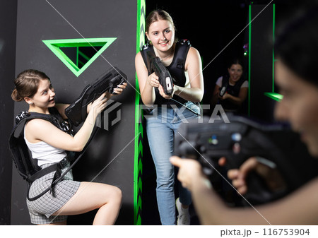 Girls play laser tag, jokingly fight with light weapons 116753904