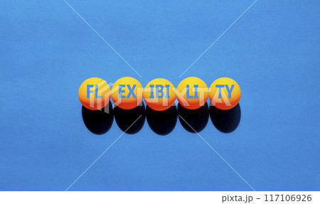 Flexibility symbol. Concept word Flexibility on beautiful yellow ping pong balls. Beautiful blue background. Business flexibility concept. Copy space. 117106926