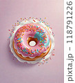 Colorful donut with pink and blue icing, topped with multicolored sprinkles, placed on a white doily against a light pink background, Generative AI. 118791226