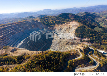 Flying above an open pit mine, copper excavation in Rosia Poieni, Romania. Aerial view 112632154