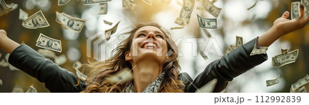 Woman standing under the rain of falling banknotes. Lottery, salary, investment, income concept. 112992839