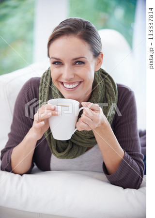 Coffee, happy and portrait of woman in home with calm, wellness and peace on sofa in living room. Morning, breakfast and person with mug relax and drinking tea, caffeine and hot beverage in house 113337814