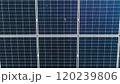 Closeup of surface of blue photovoltaic solar panels mounted on building roof for producing clean ecological electricity. Production of renewable energy concept. Drone Aerial View of solar panels. 120239806