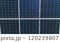 Closeup of surface of blue photovoltaic solar panels mounted on building roof for producing clean ecological electricity. Production of renewable energy concept. Drone Aerial View of solar panels. 120239807