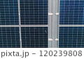 Closeup of surface of blue photovoltaic solar panels mounted on building roof for producing clean ecological electricity. Production of renewable energy concept. Drone Aerial View of solar panels. 120239808