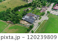 New solar farm under the blue sky. Workers in special outfit walk and talk about sunny cells installation. Modern solar panels produce clean electricity. Technicians installing solar panels. 120239809