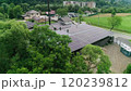 New solar farm under the blue sky. Workers in special outfit walk and talk about sunny cells installation. Modern solar panels produce clean electricity. Technicians installing solar panels. 120239812