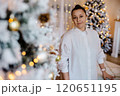 Woman in a White Shirt with Christmas Decor and Lights. 120651195