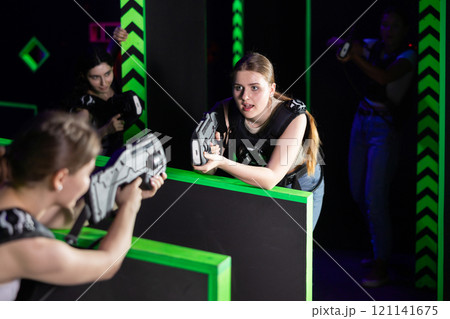 Girls play laser tag, jokingly fight with light weapons 121141675