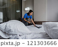 online cleaning service, hotel cleaning service clean up bedroom after guests arrive . housekeeper cleaning dust and clean bed with a vacuum cleaner. Housekeeping and house cleaning service 121303666