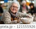 Artistic elderly woman crafting pottery in a cozy studio inspiring creativity and connection in a warm atmosphere 121555926