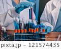 Blood test in the laboratory. Laboratory assistant working with the dispenser. Vacuum tubes with blood. 121574435