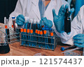 Blood test in the laboratory. Laboratory assistant working with the dispenser. Vacuum tubes with blood. 121574437