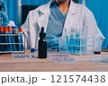 Blood test in the laboratory. Laboratory assistant working with the dispenser. Vacuum tubes with blood. 121574438