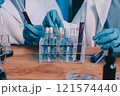 Blood test in the laboratory. Laboratory assistant working with the dispenser. Vacuum tubes with blood. 121574440