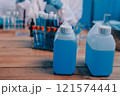 Blood test in the laboratory. Laboratory assistant working with the dispenser. Vacuum tubes with blood. 121574441