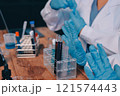 Blood test in the laboratory. Laboratory assistant working with the dispenser. Vacuum tubes with blood. 121574443