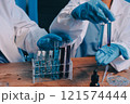 Blood test in the laboratory. Laboratory assistant working with the dispenser. Vacuum tubes with blood. 121574444