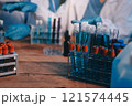 Blood test in the laboratory. Laboratory assistant working with the dispenser. Vacuum tubes with blood. 121574445